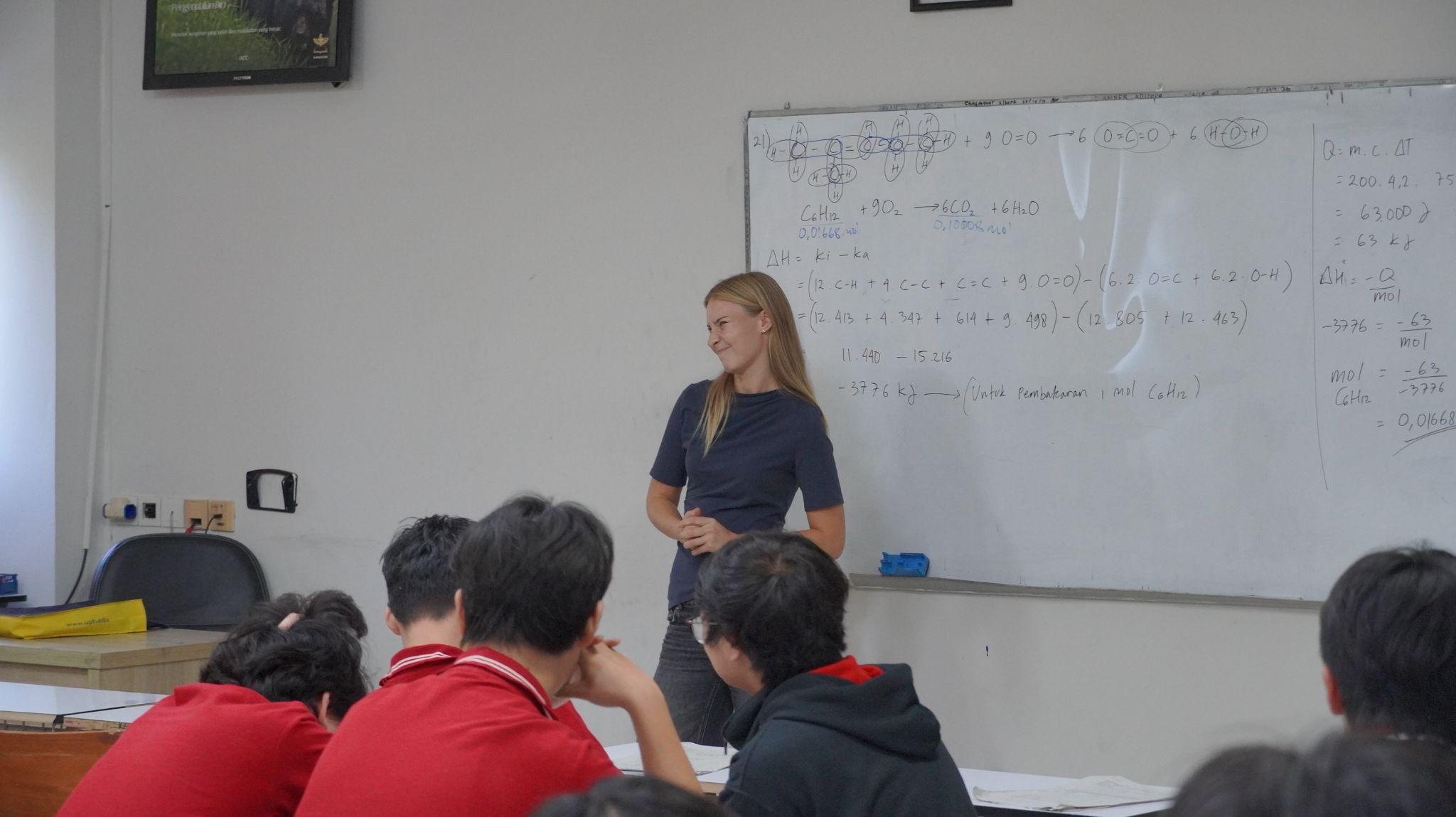 A German exchange student speaks to students in a Sekolah Karangturi classroom.