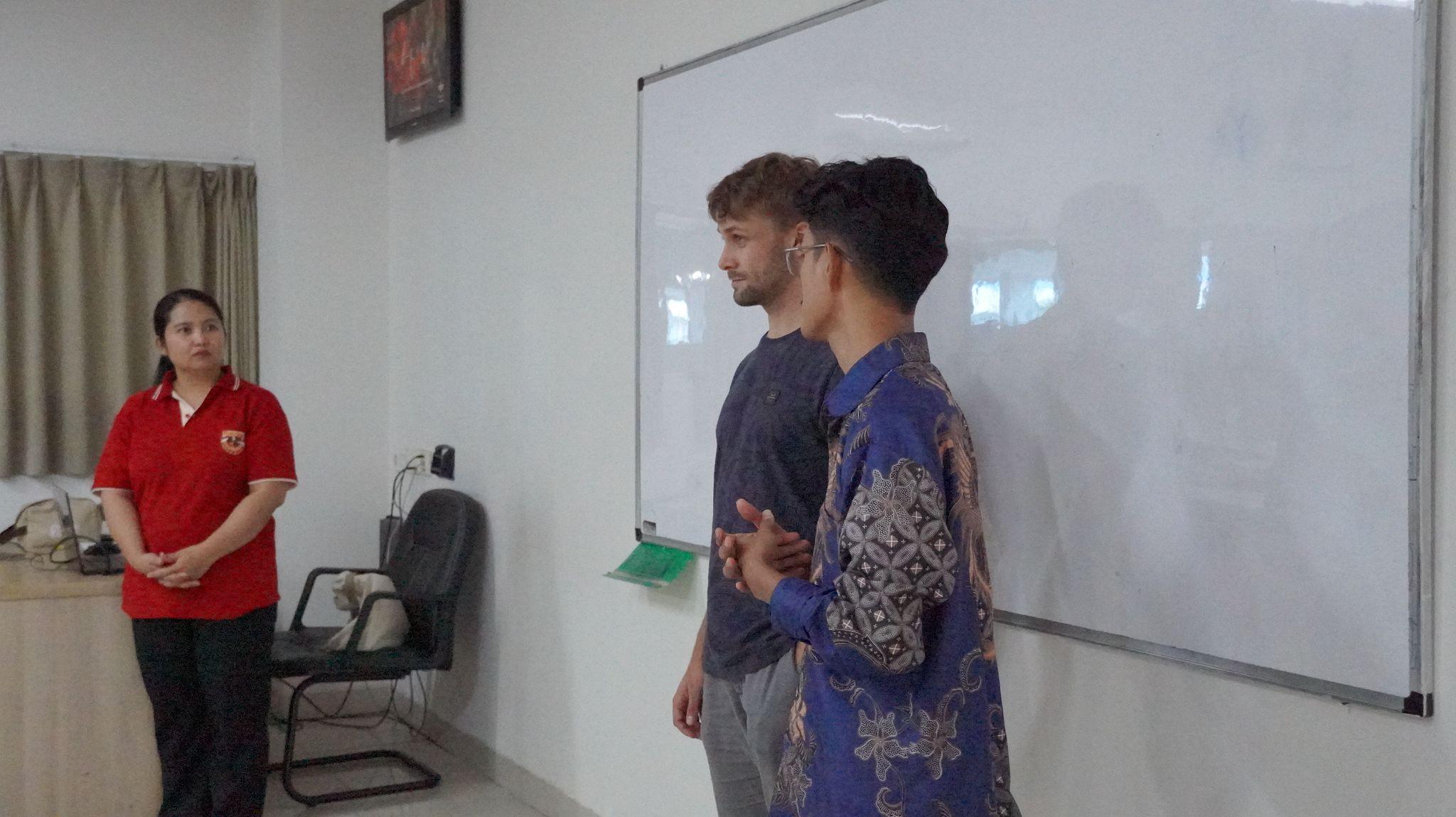 An exchange student and a local student share perspectives during a classroom discussion.